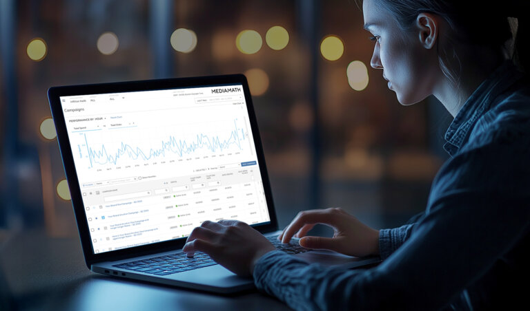 Woman using Infillion MediaMath on computer