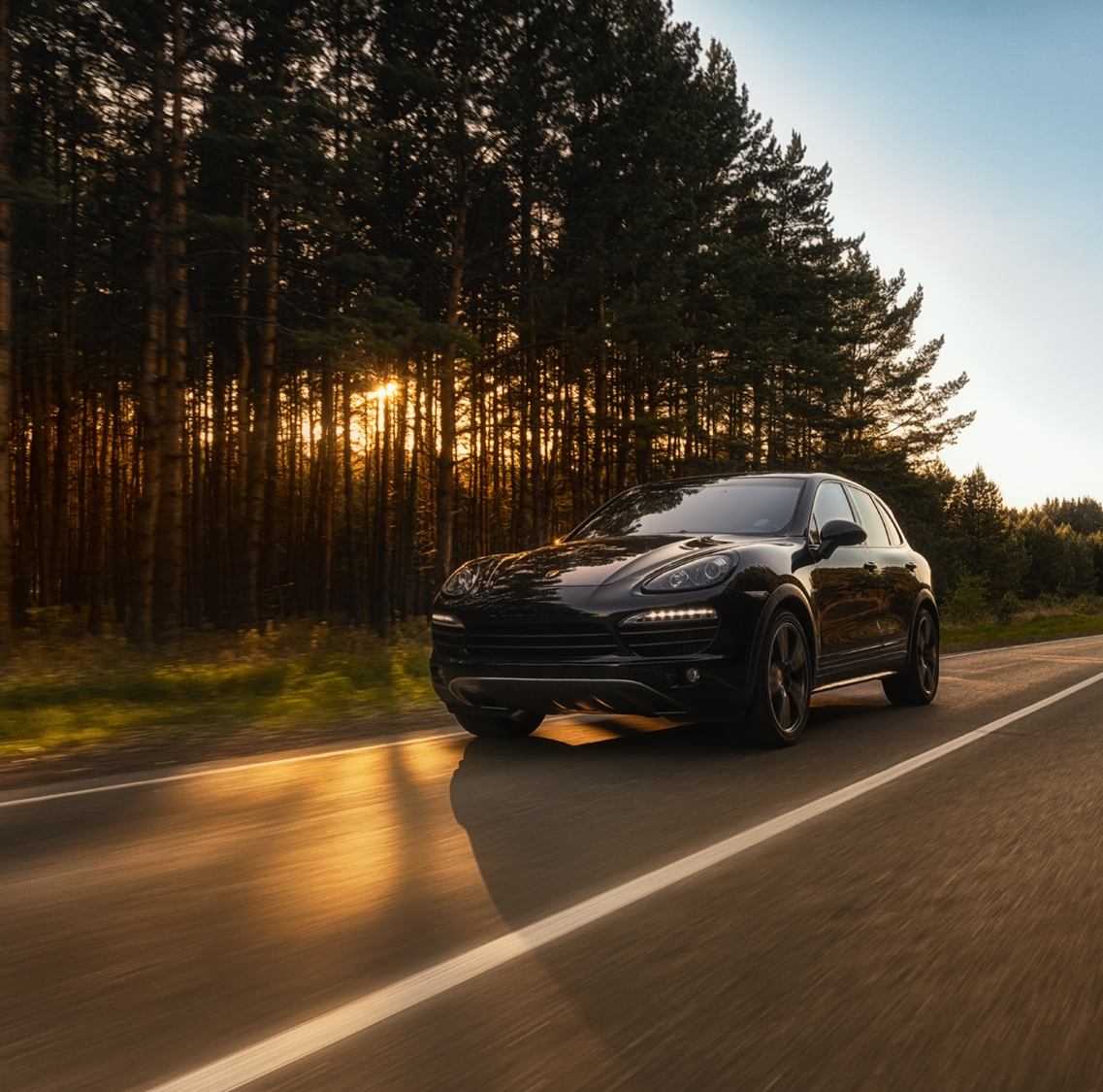 Porsche driving at sunset